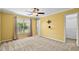 A sunlit bedroom features neutral carpet, a ceiling fan, and ample closet space for comfortable living at 305 Slate Dr, Gibsonville, NC 27249