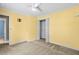 Bedroom features neutral carpet, ceiling fan, and yellow walls at 305 Slate Dr, Gibsonville, NC 27249