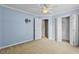 Bedroom features neutral carpet, ceiling fan, and blue walls at 305 Slate Dr, Gibsonville, NC 27249