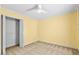 Bedroom features neutral carpet, ceiling fan, and yellow walls at 305 Slate Dr, Gibsonville, NC 27249