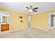 Bright bedroom features neutral carpet, ceiling fan, and yellow walls at 305 Slate Dr, Gibsonville, NC 27249