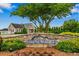 Beautiful StoneRidge entrance with stone sign and lovely landscaping, welcoming residents and visitors at 305 Slate Dr, Gibsonville, NC 27249