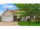 Charming single-story home featuring an attached two-car garage and manicured front lawn at 305 Slate Dr, Gibsonville, NC 27249