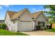 Exterior view of house showing attached garage, vinyl siding, manicured lawn, and mature tree at 305 Slate Dr, Gibsonville, NC 27249