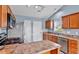 This kitchen features stainless appliances, wood cabinets, and light blue walls that create a calm space at 305 Slate Dr, Gibsonville, NC 27249