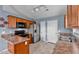 A well-lit kitchen featuring stainless appliances, ample countertops, and wood cabinets for convenient meal preparation at 305 Slate Dr, Gibsonville, NC 27249