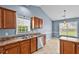 The bright kitchen sink area, featuring wood cabinets, offers a functional and stylish space for culinary tasks at 305 Slate Dr, Gibsonville, NC 27249