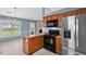 A well-lit kitchen with stainless appliances and warm cabinetry perfect for cooking and entertaining guests at 305 Slate Dr, Gibsonville, NC 27249