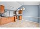 Well-lit kitchen with modern stainless steel appliances and breakfast bar seating at 305 Slate Dr, Gibsonville, NC 27249