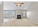 Bright living room featuring a fireplace, ceiling fan, and neutral paint colors at 305 Slate Dr, Gibsonville, NC 27249