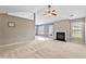 Open-concept living room with large windows, a fireplace, and a view of the kitchen at 305 Slate Dr, Gibsonville, NC 27249