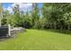 A fully fenced backyard with a sprawling lawn and patio at 347 Country Mill Way, Fuquay Varina, NC 27526