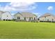 Expansive backyard showing green lawn, and a stone patio at 347 Country Mill Way, Fuquay Varina, NC 27526