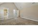 Expansive bedroom features en-suite bathroom and walk-in closet access, carpet, and neutral walls at 347 Country Mill Way, Fuquay Varina, NC 27526
