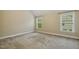 Neutral bedroom with carpet, two windows, and light-colored walls is move-in ready at 347 Country Mill Way, Fuquay Varina, NC 27526