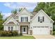 Beautiful two-story home with a manicured lawn, two-car garage, and craftsman details at 347 Country Mill Way, Fuquay Varina, NC 27526