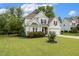 Charming two-story home featuring a well-manicured lawn, lush landscaping, and attached two-car garage at 347 Country Mill Way, Fuquay Varina, NC 27526