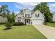 Charming two-story home features a manicured lawn, two-car garage and inviting front porch at 347 Country Mill Way, Fuquay Varina, NC 27526