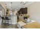 Stylish kitchen featuring a breakfast bar, stainless steel appliances, pendant lighting, and an adjacent dining area at 347 Country Mill Way, Fuquay Varina, NC 27526