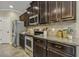 Well-equipped kitchen with stainless steel appliances, dark wood cabinets, and granite countertops for meal preparation at 347 Country Mill Way, Fuquay Varina, NC 27526