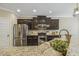 Kitchen featuring stainless steel appliances, dark cabinets, and gorgeous granite countertops at 347 Country Mill Way, Fuquay Varina, NC 27526
