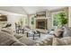 Comfortable living room with stone fireplace, neutral tones, and ample natural light from the surrounding windows at 347 Country Mill Way, Fuquay Varina, NC 27526