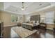 Bright main bedroom features tray ceilings, hardwood floors, and a cozy sitting area at 347 Country Mill Way, Fuquay Varina, NC 27526
