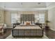 Spacious main bedroom offers hardwood floors, a large bed, and ample natural light at 347 Country Mill Way, Fuquay Varina, NC 27526