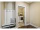 A conveniently located mudroom featuring a bench, coat hooks and access to the laundry area at 347 Country Mill Way, Fuquay Varina, NC 27526