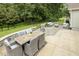 Landscaped backyard patio with cushioned outdoor dining and seating at 347 Country Mill Way, Fuquay Varina, NC 27526