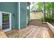 Wood deck with a white door and view of the wooded backyard, and a neighboring yellow house at 3511 Shady Creek Dr, Durham, NC 27713