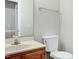Bathroom featuring a white toilet, wooden vanity, and a gold towel bar at 3511 Shady Creek Dr, Durham, NC 27713