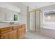 Bathroom featuring dual sinks, a shower stall, and a bathtub with a window view at 3511 Shady Creek Dr, Durham, NC 27713