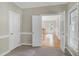 Bedroom with an open doorway showcasing hardwood floors and natural light at 3511 Shady Creek Dr, Durham, NC 27713