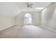 Large carpeted bedroom featuring a ceiling fan, a skylight and an arched window at 3511 Shady Creek Dr, Durham, NC 27713