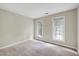 Neutral bedroom with plush carpet and two windows offering beautiful outdoor views at 3511 Shady Creek Dr, Durham, NC 27713