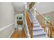 Inviting foyer with hardwood floors, a staircase, and views into the kitchen at 3511 Shady Creek Dr, Durham, NC 27713