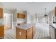 Kitchen with wood cabinets, an island, open to the living area, creating a seamless flow at 3511 Shady Creek Dr, Durham, NC 27713