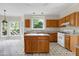 View of the kitchen with ample counter space, wood cabinetry, and views of the backyard at 3511 Shady Creek Dr, Durham, NC 27713
