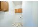 Functional laundry room with upper cabinets, tiled floors, and ample space at 3511 Shady Creek Dr, Durham, NC 27713