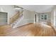 Open-concept space with hardwood floors, a staircase, and natural light at 3511 Shady Creek Dr, Durham, NC 27713