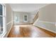 Bright and airy living room with hardwood floors, large windows and staircase to the second floor at 3511 Shady Creek Dr, Durham, NC 27713