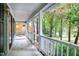 Cozy porch with white railings and a swing overlooking the lush greenery at 3511 Shady Creek Dr, Durham, NC 27713