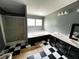 Full bathroom with black and white checkered tile, shower, and soaking tub at 4040 Tyler Dr, Oxford, NC 27565