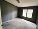 The carpeted bedroom has windows for plenty of natural light and a ceiling fan at 4040 Tyler Dr, Oxford, NC 27565