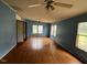 Bright living room featuring hardwood floors, ample natural light, and fresh blue paint at 4040 Tyler Dr, Oxford, NC 27565