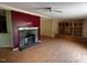 Open living area with hardwood floors, a stone fireplace, and custom built-ins for storage and display at 4040 Tyler Dr, Oxford, NC 27565