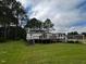 Rear exterior view showcasing an expansive deck and backyard, perfect for outdoor entertaining at 4040 Tyler Dr, Oxford, NC 27565