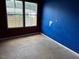 An empty room with a blue accent wall and bright natural light at 4040 Tyler Dr, Oxford, NC 27565