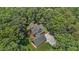 Beautiful aerial view of a home surrounded by lush green trees with ample parking space at 4110 Stoneycreek Rd, Chapel Hill, NC 27514
